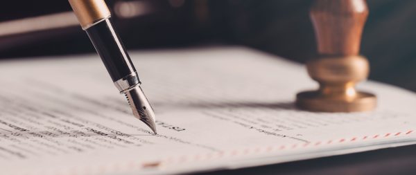 Law, notary background theme. Fountain pen and handmade paper on desk